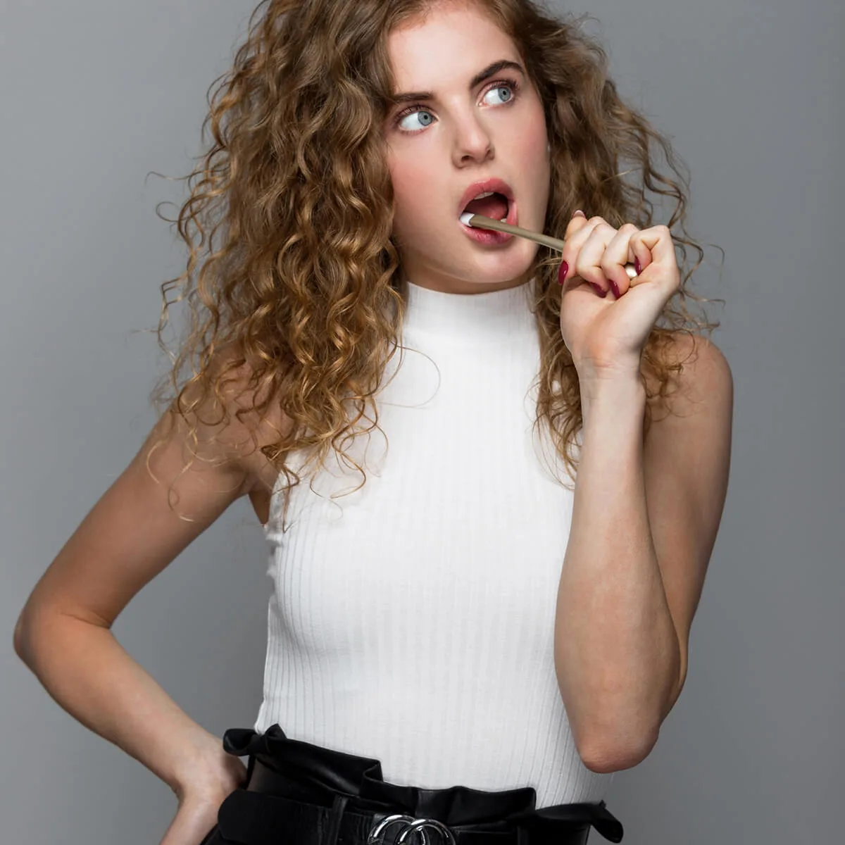 Woman putting an alternative+ toothpaste tab in her mouth